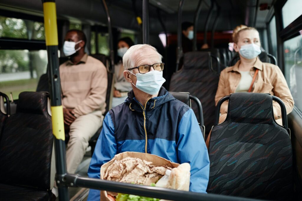 Senior Man Wearing Mask on Bus
